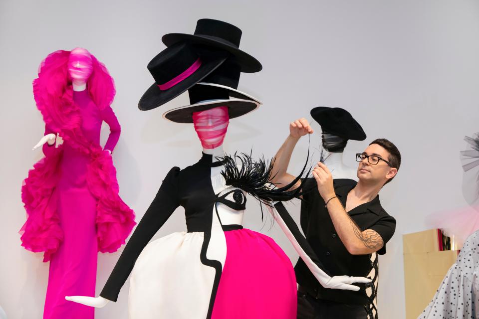 Christian Siriano works on installing a Janelle Monáe gown at the "People Are People" exhibit in Georgia. The exhibit opened March 22 at the Memphis Brooks Museum of Art.