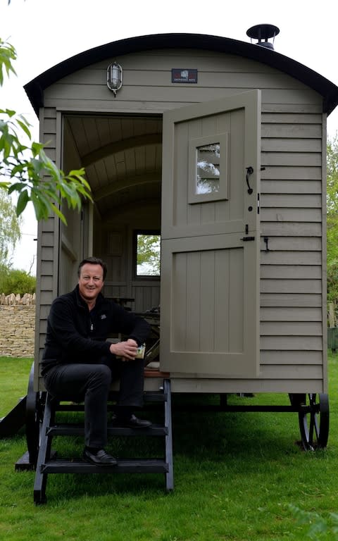David Cameron sitting on the steps of a luxury cabin he has had installed in his Cotswolds garden - Credit: Graham Flack/Red Sky Shepherds Huts 