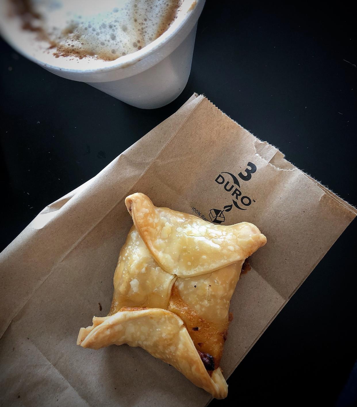 Quick bite: a ham-and-cheese empanada and frothy cappuccino at Enzo's in Palm Springs.