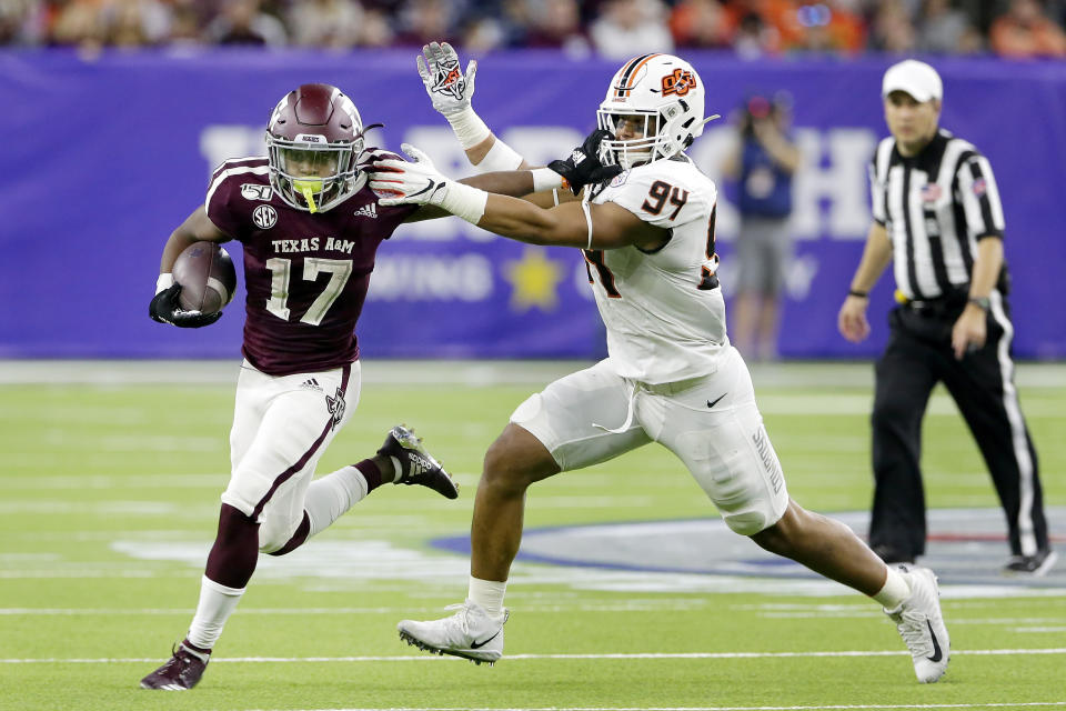 Texas A&M wide receiver Ainias Smith (17) fends off Oklahoma State defensive end Trace Ford (94) during the first half of the Texas Bowl NCAA college football game Friday, Dec. 27, 2019, in Houston. (AP Photo/Michael Wyke)