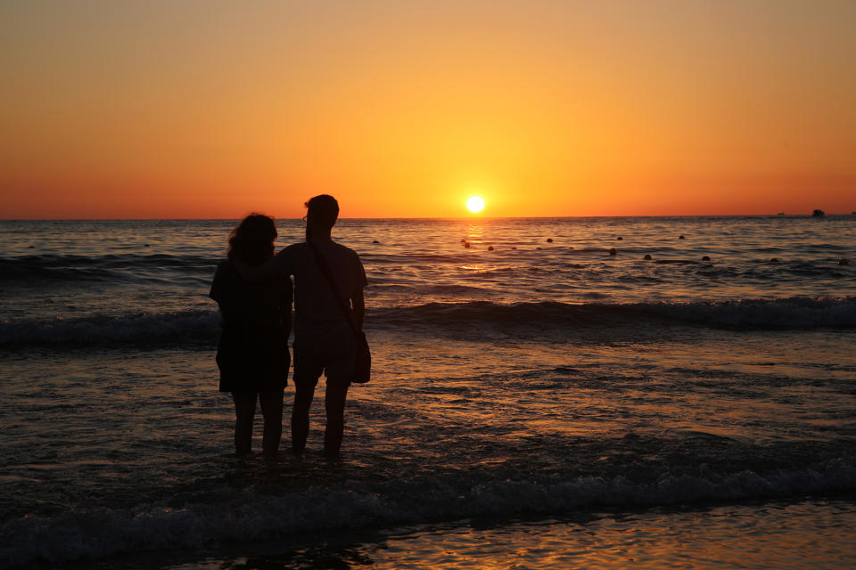 Couple watches sun set