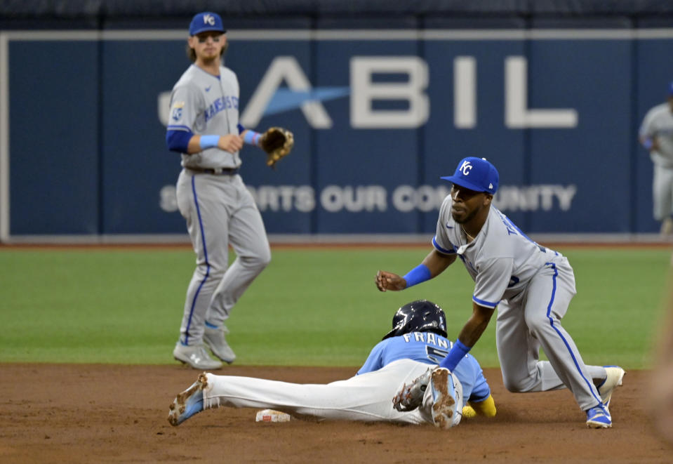 Kansas City Royals shortstop Bobby Witt Jr., left, looks on as Tampa Bay Rays' Wander Franco, bottom right, beats a tag by Royals second baseman Samad Taylor for a stolen base during the fourth inning of a baseball game Sunday, June 25, 2023, in St. Petersburg, Fla. (AP Photo/Steve Nesius)