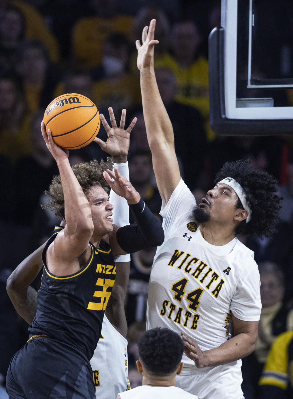 Wichita State's Isaiah Poor Bear Chandler, right, defends against Missouri's Noah Carter during the first half of an NCAA college basketball game Tuesday, Nov. 29, 2022, in Wichita, Kan. (Travis Heying/The Wichita Eagle via AP)