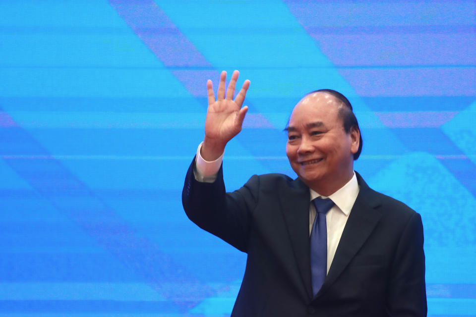 Vietnamese Prime Minister Nguyen Xuan Phuc waves after concluding the signing ceremony of the Regional Comprehensive Economic Partnership, or RCEP, trade agreement in Hanoi, Vietnam on Sunday, Nov. 15, 2020. China and 14 other countries agreed Sunday to set up the world’s largest trading bloc, encompassing nearly a third of all economic activity, in a deal many in Asia are hoping will help hasten a recovery from the shocks of the pandemic. (AP Photo/Hau Dinh)