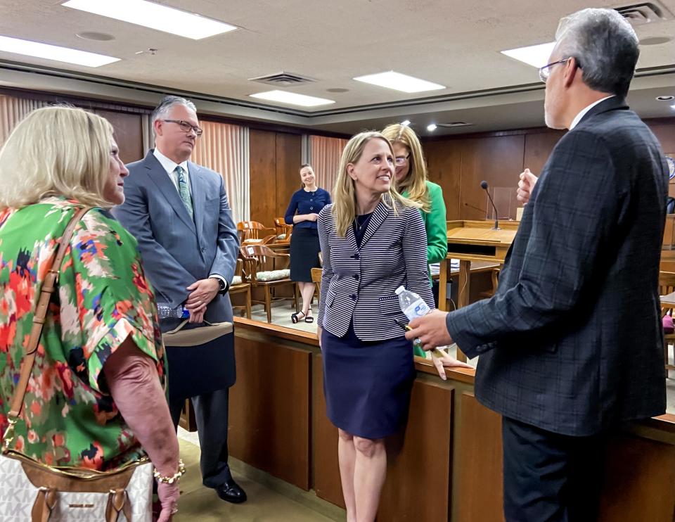 Attorney Cara Nicklas, center, talks with First United Methodist Church leaders, from left, Ruth Schwab, Hardy Patton and David Hancock after Judge Aletia Timmons ruled in the church's favor on Monday in Oklahoma County District Court. [Carla Hinton]