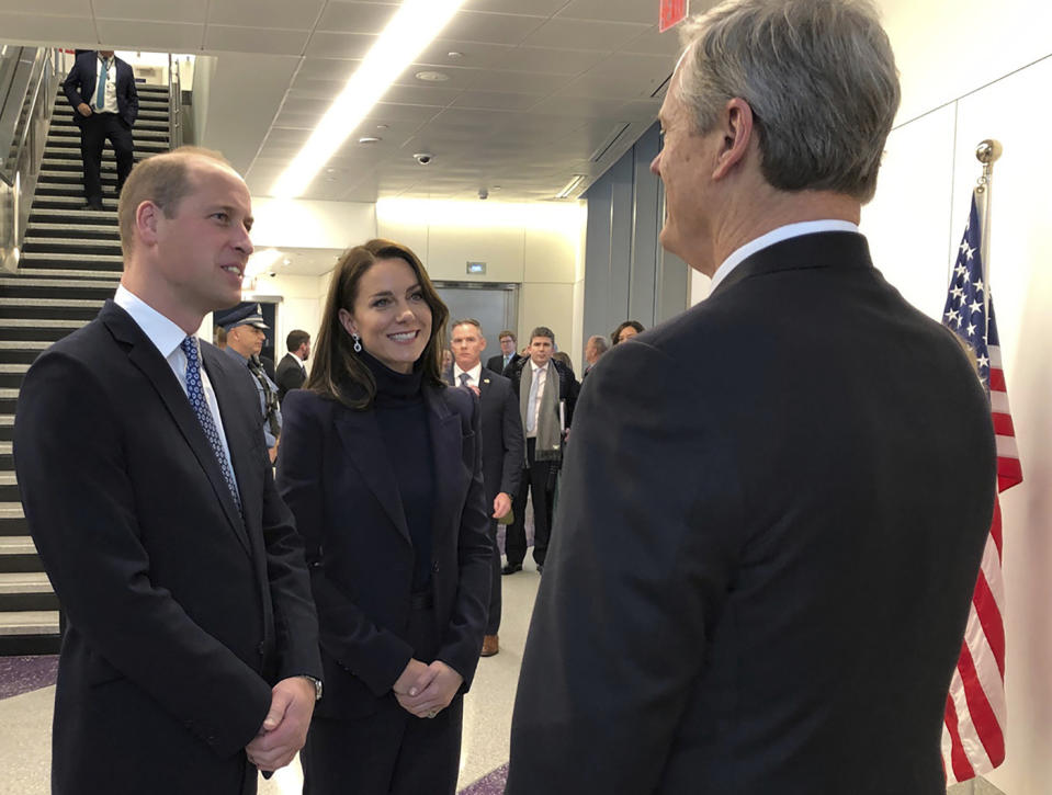 Britain's Prince William and Catherine, Princess of Wales are greeted by Massachusetts Governor Charlie Baker at Boston Logan International Airport on Wednesday, Nov. 30, 2022, in Boston. The Prince and Princess of Wales are making their first overseas trip since the death of Queen Elizabeth II in September. (John Tlumacki/The Boston Globe via AP, Pool)