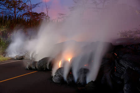 Volcanic gases rise from the Kilauea lava flow that crossed Pohoiki Road near Highway 132, near Pahoa, Hawaii, May 28. REUTERS/Marco Garcia