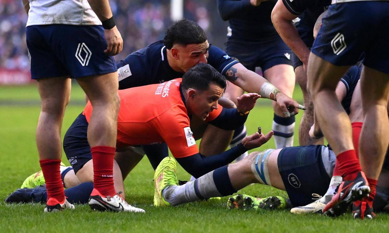 <span>Referee Nic Berry signals that the ball is held up, denying Sam Skinner of Scotland (obscured) a try against France.</span><span>Photograph: Stu Forster/Getty Images</span>