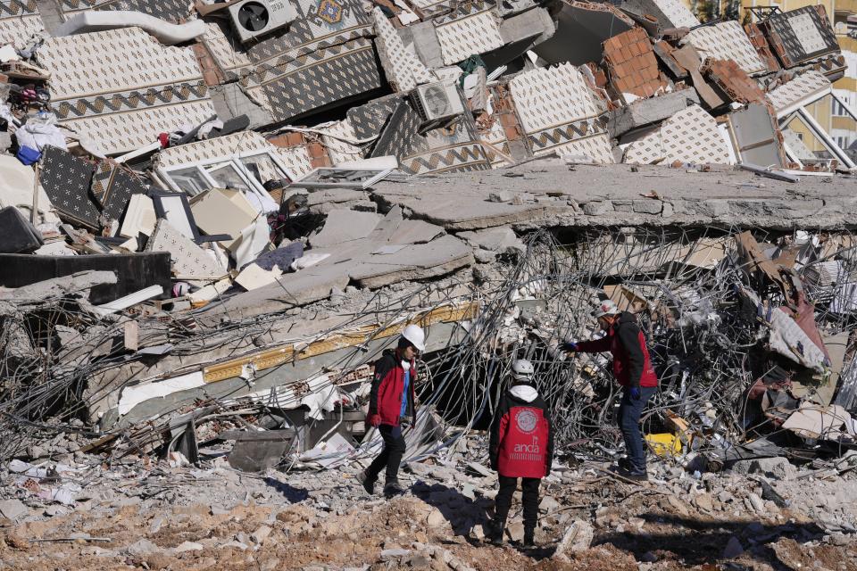 Rescuers search on a destroyed building in Gaziantep, southeastern Turkey, Thursday, Feb. 9, 2023. Rescuers pulled more survivors from beneath the rubble of collapsed buildings Thursday, but hopes were starting to fade of finding many more people alive more than three days after a catastrophic earthquake and series of aftershocks hit Turkey and Syria. (AP Photo/Kamran Jebreili)