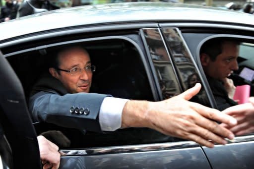 Newly elected president Francois Hollande leaves his campaign headquarters in Paris, one day after the announcement of the first official results of the French presidential second round