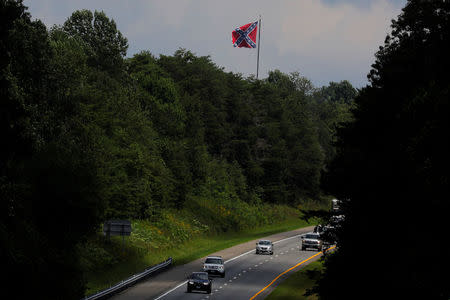 A Confederate battle flag flies over the I-64 highway, ahead the one-year anniversary of the fatal white-nationalist rally, outside Charlottesville, Virginia, U.S., August 1, 2018. REUTERS/Brian Snyder