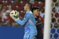 Austin FC goalkeeper Brad Stuver, left, grabs the ball in front of FC Dallas attacker Marco Farfan, right, during the first half of an MLS soccer match Saturday, May 11, 2024, in Frisco, Texas. (AP Photo/LM Otero)