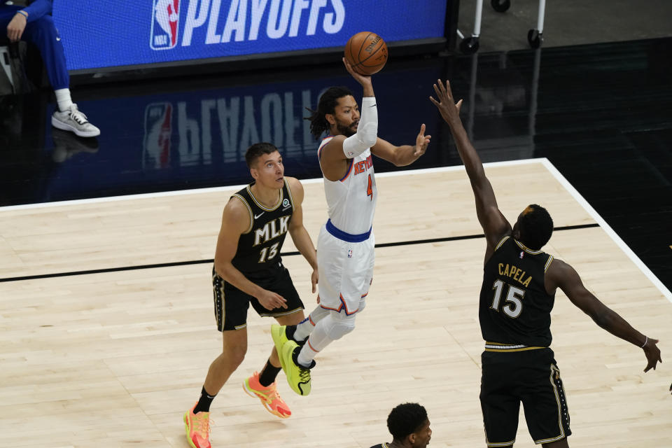 New York Knicks' Derrick Rose (4) shoots against Atlanta Hawks' Clint Capela (15) during the first half in Game 4 of an NBA basketball first-round playoff series Sunday, May 30, 2021, in Atlanta. (AP Photo/Brynn Anderson)