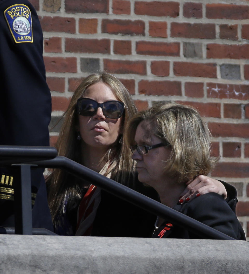 Kathy Crosby-Bell, right, mother of Boston firefighter Michael R. Kennedy, walks up the steps of Holy Name Church for her son's funeral in Boston, Thursday, April 3, 2014. Kennedy and Boston Fire Lt. Edward J. Walsh were killed Wednesday, March 26, 2014 when they were trapped in the basement of a burning brownstone during a nine-alarm blaze.(AP Photo/Stephan Savoia)