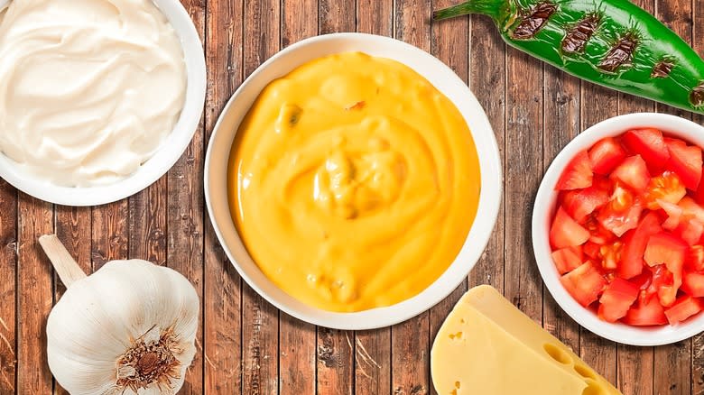 Bowl of queso with condiments