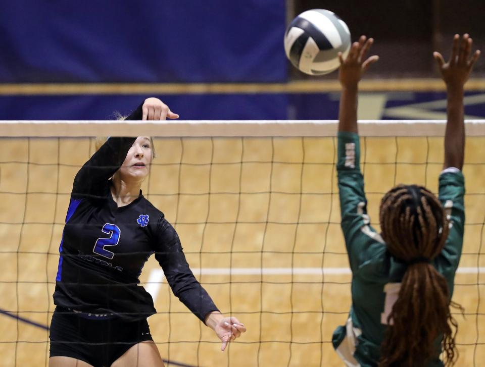 CVCA sophomore Reese Donahoe, left, hits the ball past STVM senior Myah Hammond during a Division II sectional Oct. 19, 2022, in Akron.