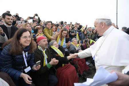 Pope Francis meets the faithful outside the 'White Houses' in the Forlanini district of Milan, Italy, March 25, 2017. Osservatore Romano/Handout via Reuters