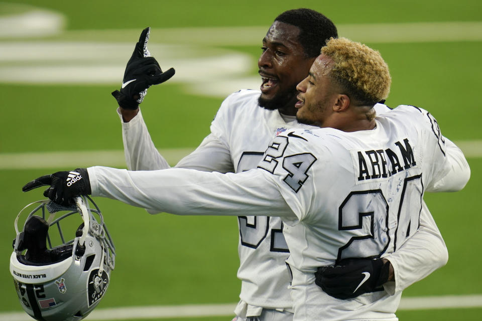 Las Vegas Raiders cornerback Isaiah Johnson, left, and strong safety Johnathan Abram (24) celebrate after the Raiders defeated the Los Angeles Chargers in an NFL football game Sunday, Nov. 8, 2020, in Inglewood, Calif. (AP Photo/Alex Gallardo)