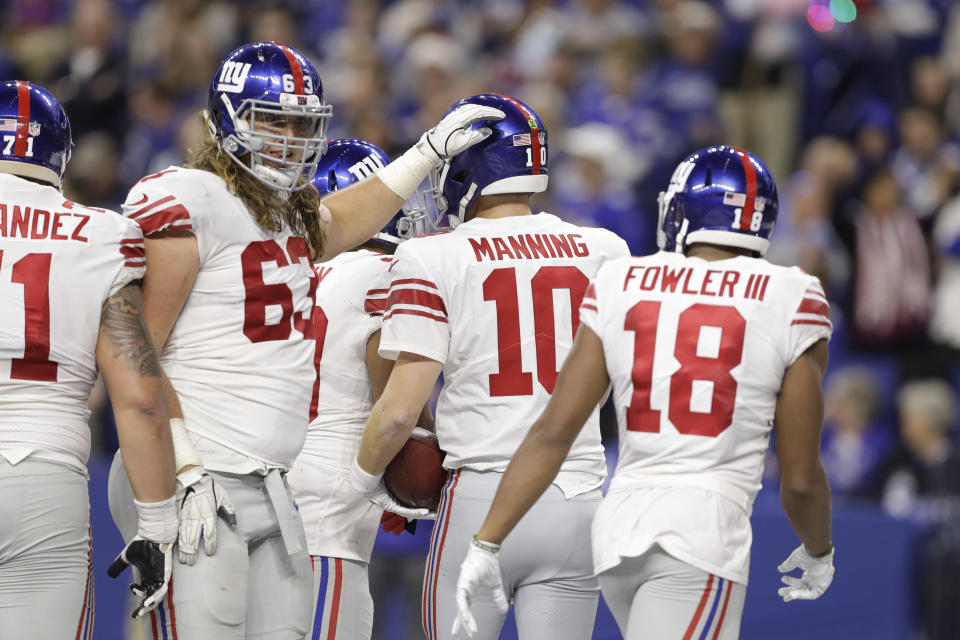New York Giants quarterback Eli Manning (10) is congratulated by offensive tackle Chad Wheeler (63) after scoring a touchdown against the Indianapolis Colts during the second half of an NFL football game in Indianapolis, Sunday, Dec. 23, 2018. (AP Photo/Darron Cummings)