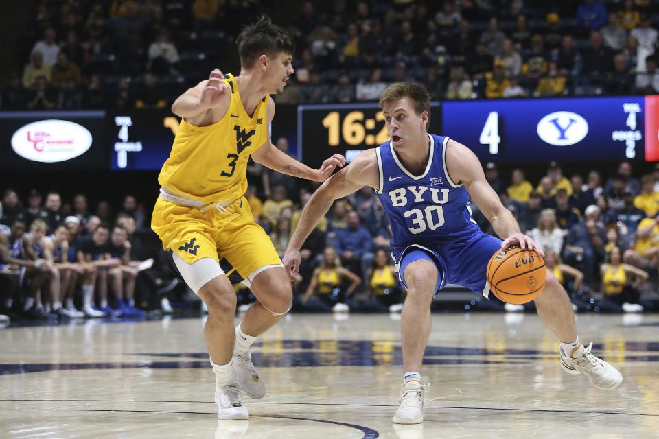 BYU guard Dallin Hall is defended by West Virginia guard Kerr Kriisa during a game Saturday, Feb. 3, 2024, in Morgantown, W.Va. | Kathleen Batten, Associated Press