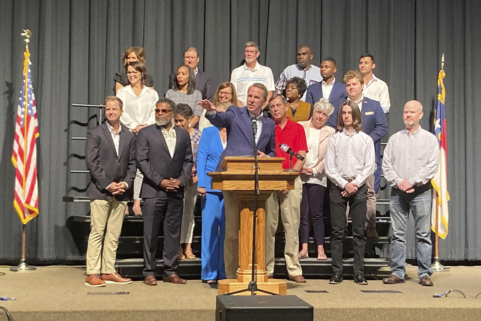 Former U.S. Rep. Mark Walker, R-N.C., left, speaks with Ginger Rhoads, 43, of Graham, North Carolina, center, and Scott Rhoads, 54, of Graham at Triad Baptist Church in Kernersville, North Carolina on Saturday, May 20, 2023. Walker spoke with supporters before he announced his 2024 for governor at a rally held at the church (AP Photo/Gary D. Robertson)