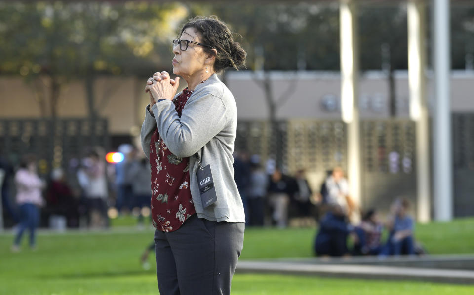 A woman stands outside Lakewood Church, in Houston, after a reported shooting during a Spanish church service, Sunday, Feb. 11, 2024. (Karen Warren/Houston Chronicle via AP)