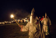 <p>Members of the Ku Klux Klan participate in cross burnings after a “white pride” rally in rural Paulding County near Cedar Town, Ga., April 23, 2016. (Photo: John Bazemore/AP) </p>
