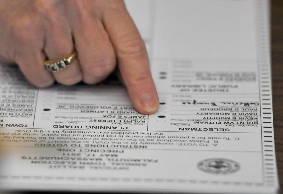 Election workers hand count ballots during the 2011 town election in Falmouth.