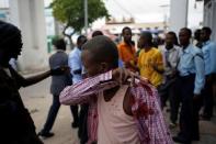 An injured man walks from the scene of a suicide bomb attack outside Nasahablood hotel in Somalia's capital Mogadishu, June 25, 2016. REUTERS/Feisal Omar