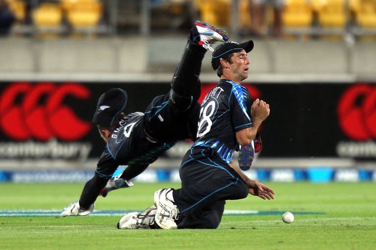 New Zealand's Grant Elliott (right) and Brendon McCullum fall over each other trying to take a catch from England's Michael Lumb during their Twenty20 match at the Westpac Stadium in Wellington on February 15, 2013. Alex Hales produced a batting masterclass as England dominated New Zealand with both bat and ball to race to a 10-wicket win in the T20 series decider in Wellington