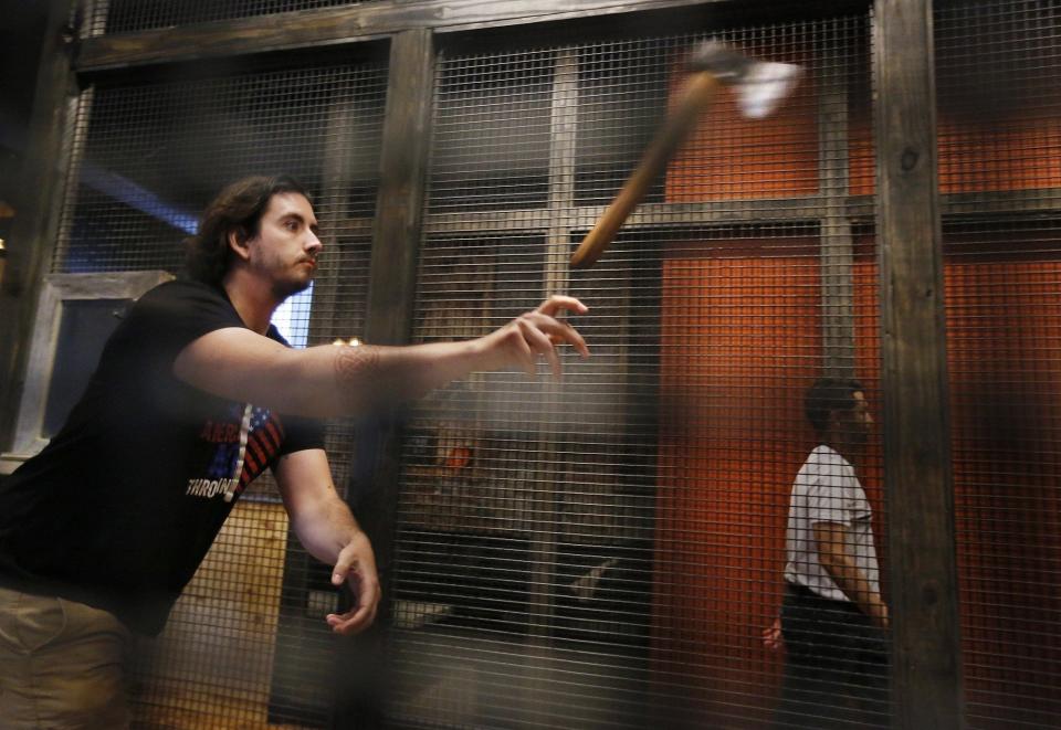 Tyler Flynn of Cleveland throwing his ax in a ax throwing tournament at Dueling Axes in Columbus in 2019.