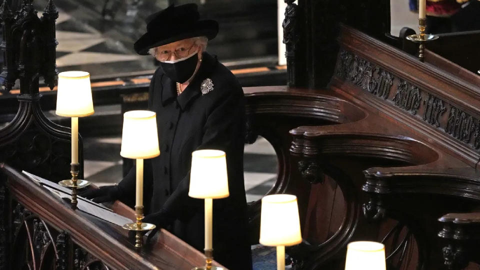 Queen Elizabeth II watches as pallbearers carry the coffin of Prince Philip, Duke Of Edinburgh into St George's Chapel