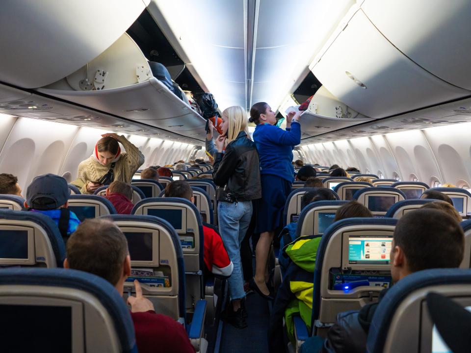 Economy class seen from the aisle of an airplane