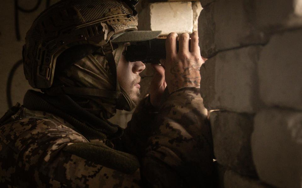 A member of the Ukraine Foreign Legion searches for Russian positions on the west bank of the Dnipro River - Chris McGrath/Getty