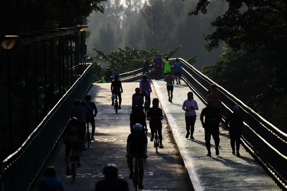 People cycle and jog at a park on September 26, 2021 in Singapore.  (Photo by Suhaimi Abdullah/NurPhoto via Getty Images)