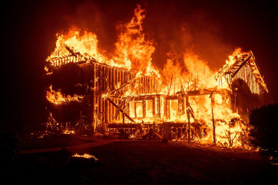 A home burns as the Camp Fire rages through Paradise, Calif., on Thursday, Nov. 8, 2018.