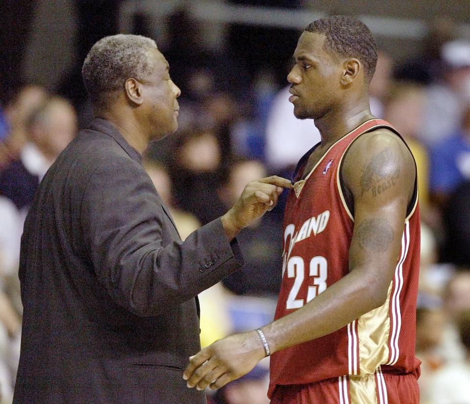 Cleveland Cavaliers' head coach Paul Silas, left, talks with LeBron James, right, during their game against the Atlanta Hawks in Asheville, N.C., Wednesday, Oct. 8, 2003. (AP Photo/Chuck Burton)