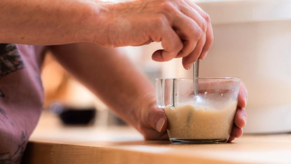 woman mixing yeast for making homemade bread