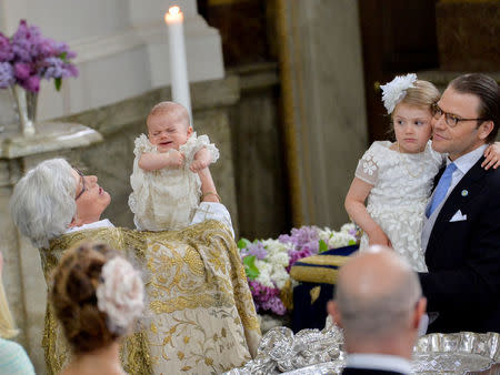 Archbishop Antje Jackelen holds Prince Oscar, during his christening, while Princess Estelle and Prince Daniel look on at the Royal Palace Chapel in Stockholm, Sweden May 27, 2016.TT News Agency/Jonas Ekstromer/via REUTERS