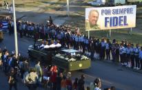 As a military jeep drove Fidel Castro's urn thousands who lined the streets of Santiago shouted "viva Fidel!"