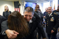 Deported veteran Mauricio Hernandez Mata, center, gets a hug after being sworn in as U.S. citizens at a special naturalization ceremony Wednesday, Feb. 8, 2023, in San Diego. The Army veteran who fought in Afghanistan is among 65 veterans who have been allowed back into the United States nearly a year ago as part of a growing effort by the U.S. government to recognize the service of immigrants who served in the U.S. military only to wind up deported.(AP Photo/Gregory Bull)