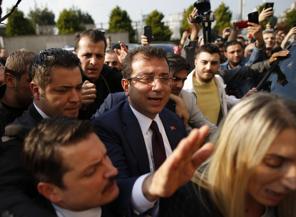 Ekrem Imamoglu, centre, of the opposition Republican People's Party (CHP) mayoral candidate in Istanbul, arrives to receive a certificate confirming his win by a slim margin against ruling party's candidate Binali Yildirim, in Istanbul, Turkey, Wednesday, April 17, 2019. Authorities have confirmed that Imamoglu won the mayoral election in Istanbul, ending nearly three weeks of recounts, although Turkey's top electoral body, has yet to consider a ruling party request for the vote in Istanbul to be invalidated. (AP Photo/Emrah Gurel)