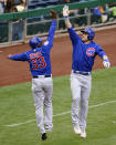 Chicago Cubs' Patrick Wisdom, right, celebrates with third base coach Willie Harris (33) as he rounds third after hitting a three-run home run off Pittsburgh Pirates relief pitcher Manny Banuelos during the fifth inning of a baseball game in Pittsburgh, Sunday, Sept. 25, 2022. (AP Photo/Gene J. Puskar)