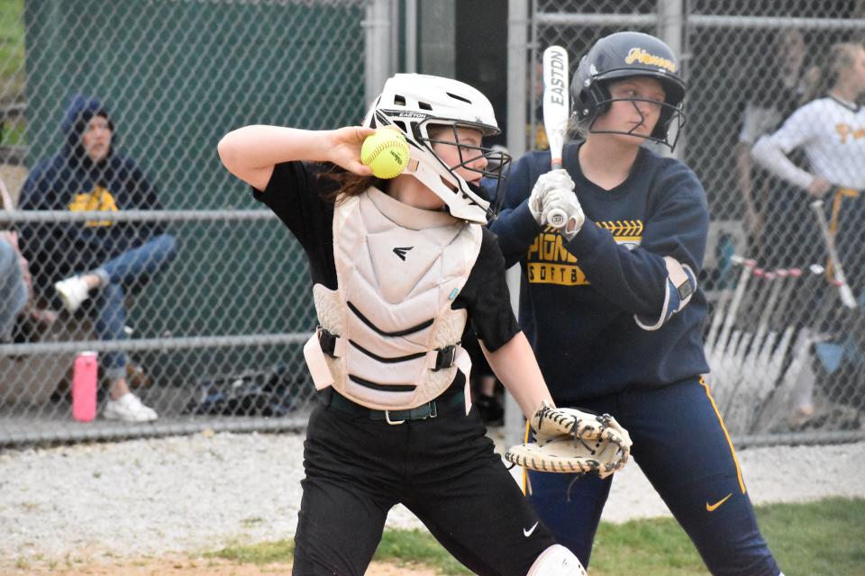 Monrovia catcher Piper Carpenter tosses the ball back to pitcher Alexandria Baker during the Bulldogs' game with Mooresville on April 15, 2022.