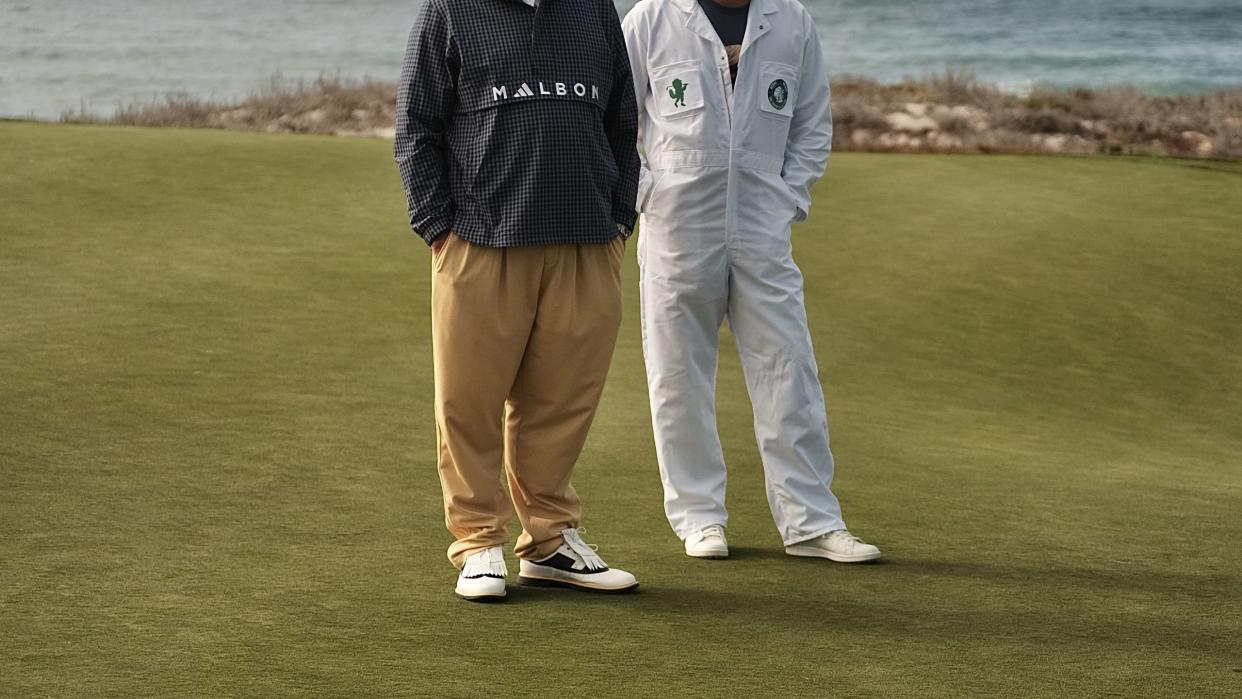 two men standing on a golf course