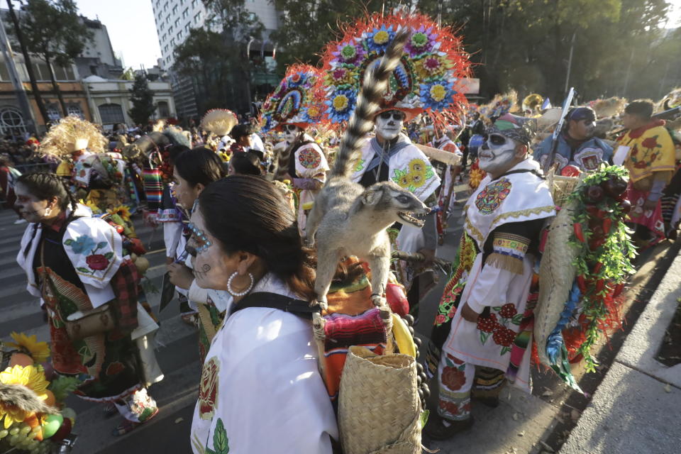 Participants take part in a James Bond-inspired Day of the Dead Parade, in Mexico City, Saturday, Nov. 4, 2023. The Hollywood-style parade was adopted in 2016 by Mexico City to mimic a fictitious march in the 2015 James Bond movie “Spectre.” (AP Photo/Ginnette Riquelme)
