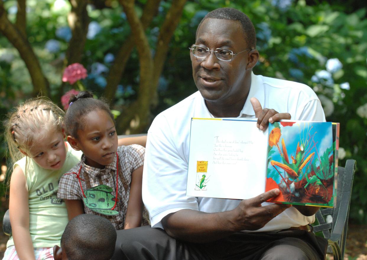 Ed Tarver reads the children's book "Miss Spider's New Car" to children from Loving Tots Daycare, Bessie's Child Care and Children Unique Christian Daycare, during Story Time at Pendleton Park, in this photo from 2008. Tarver died Feb. 9, 2024, at age 64.