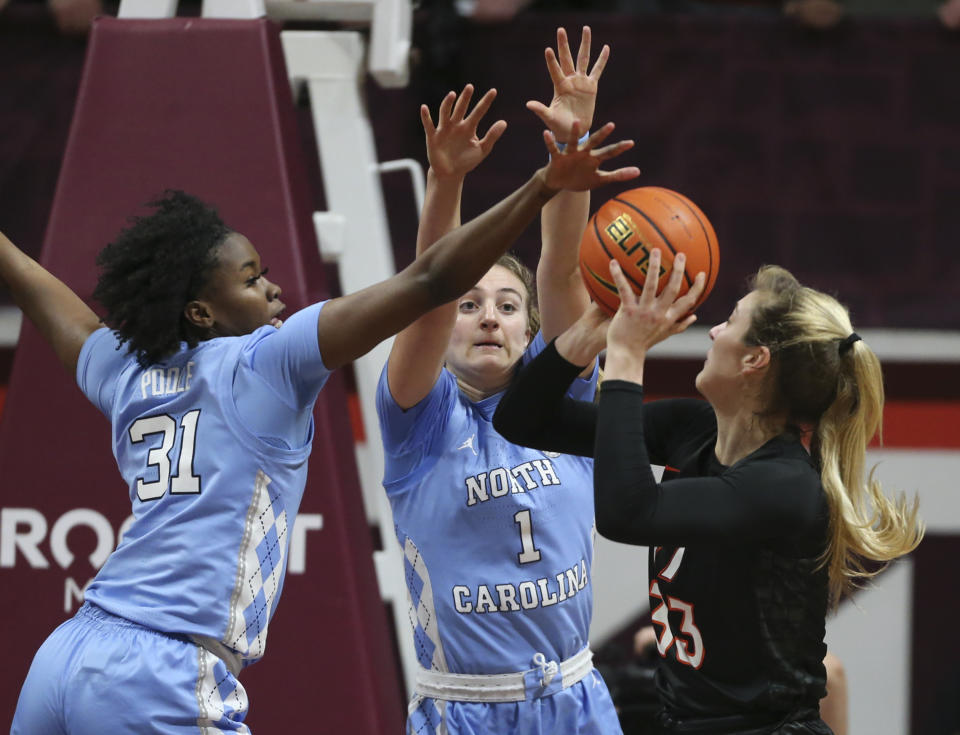 North Carolina's Anya Poole (31) and Alyssa Ustby (1) defend Virginia Tech's Elizabeth Kitley (33) in the first half of the North Carolina Virginia Tech women's NCAA basketball game in Blacksburg Va., on Saturday, Feb. 12 2022. (Matt Gentry/The Roanoke Times via AP)