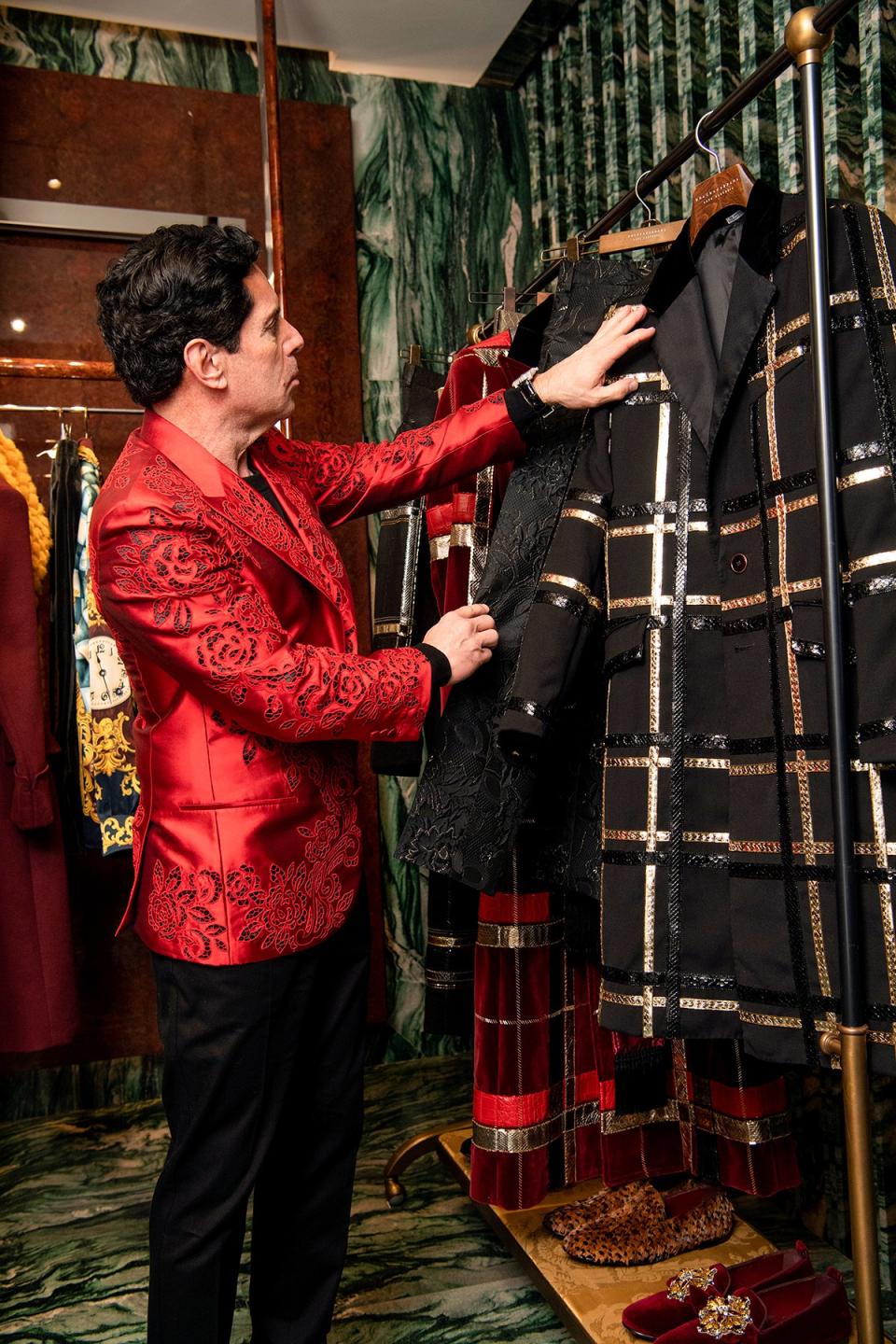 Scott Hershman, another client, admires a coat with snakeskin accents.