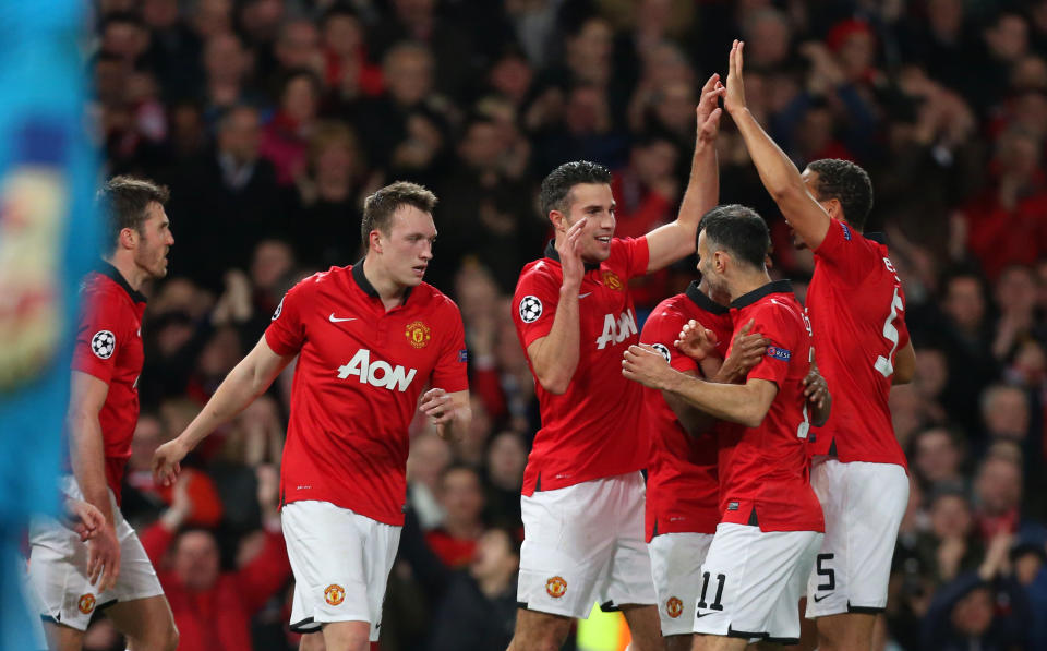 Manchester United's Robin van Persie, third left, celebrates his hatrick and scoring his side's third goal with his teammates during their Champions League last 16 second leg soccer match against Olympiakos at Old Trafford Stadium, Manchester, England, Wednesday, March 19, 2014. (AP Photo/Jon Super)